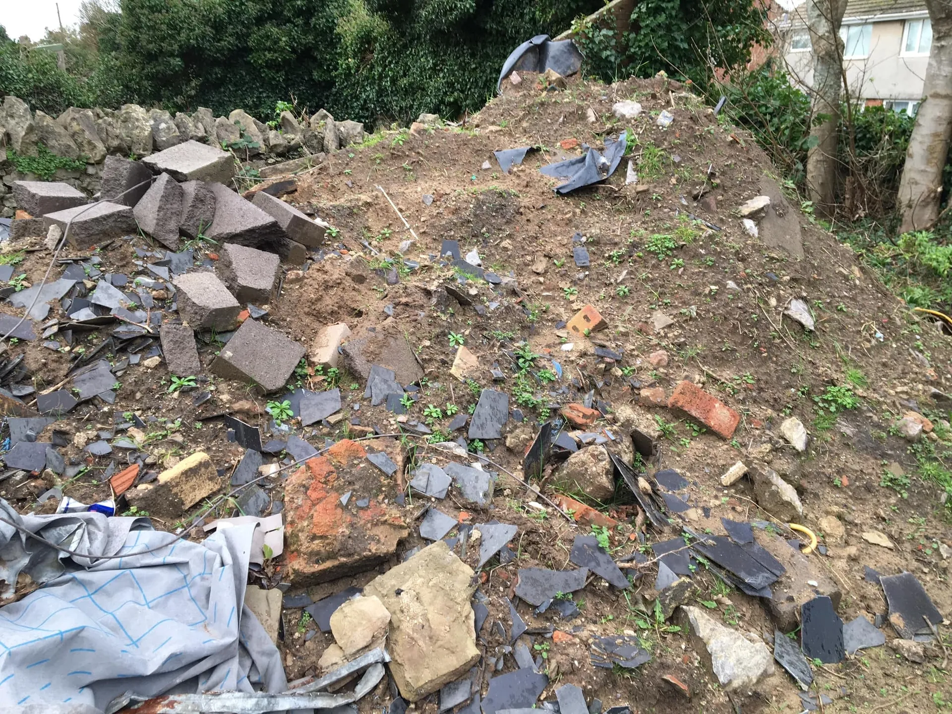 a photo of earth and rubble next to trees in Neath, Port Talbot, And Swansea