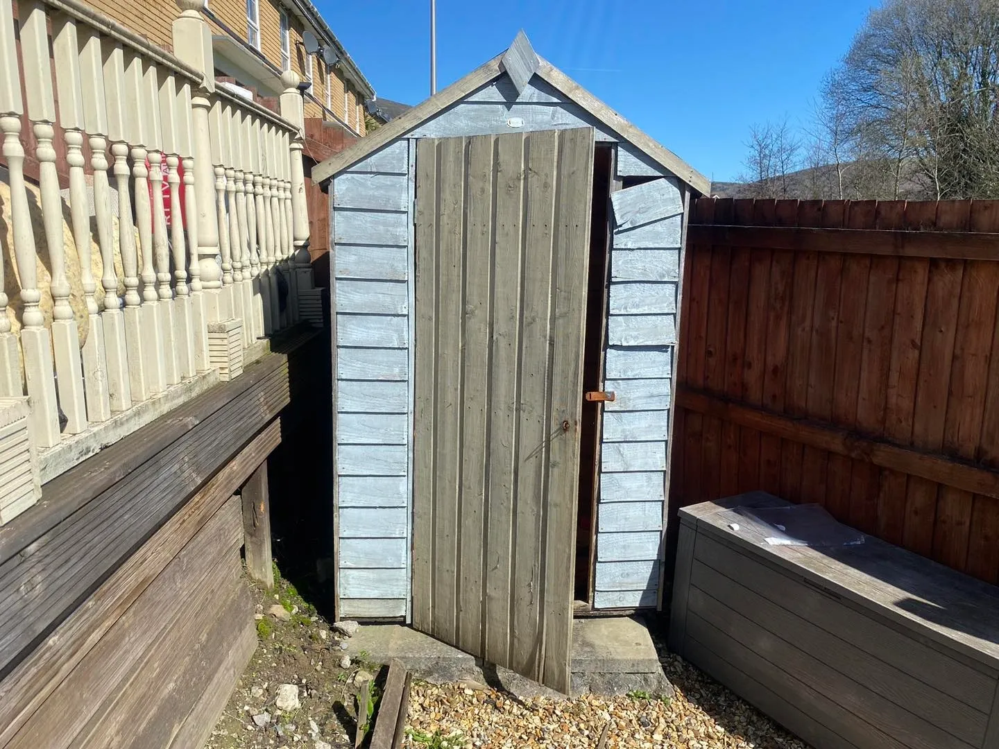 a photo of a shed next to a fence with a piece of wood beside it in Neath, Port Talbot, and Swansea