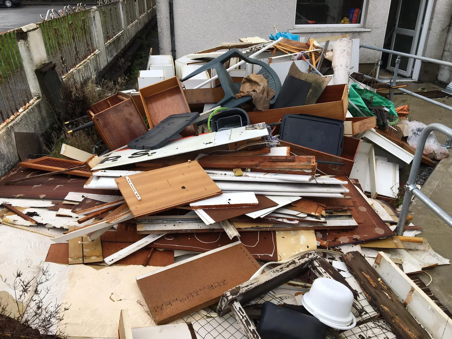 a photo of a garden full of wood and junk in Neath, Port Talbot, and Swansea