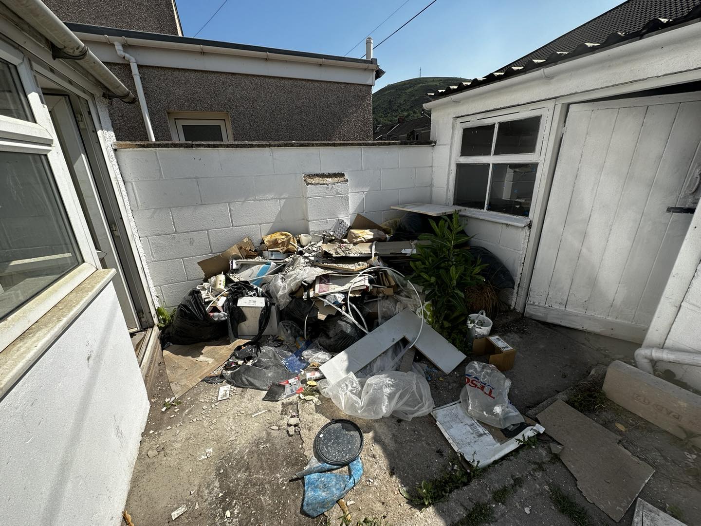 a photo of a shed with windows and junk in front in Neath, Port Talbot, And Swansea