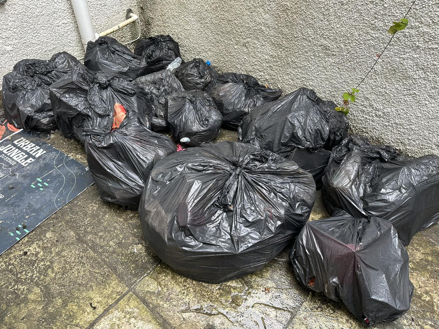 a photo of black bags by a wall in Neath, Port Talbot, And Swansea