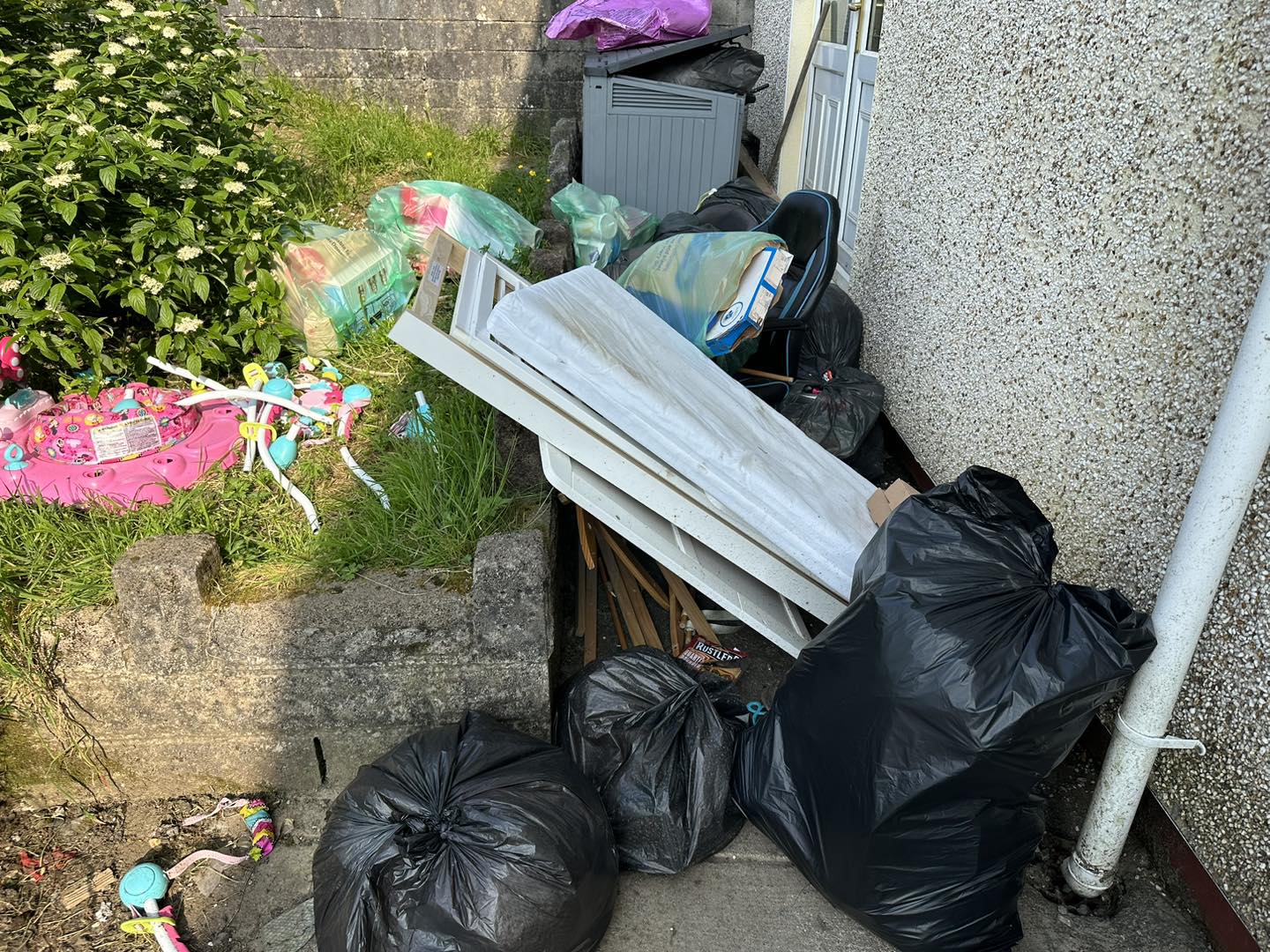 a photo of junk in a garden in Neath, Port Talbot, And Swansea