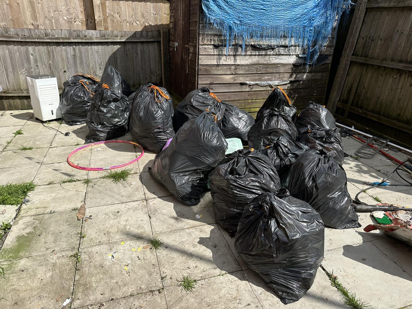 a photo of black bags next to a shed in Neath, Port Talbot, And Swansea