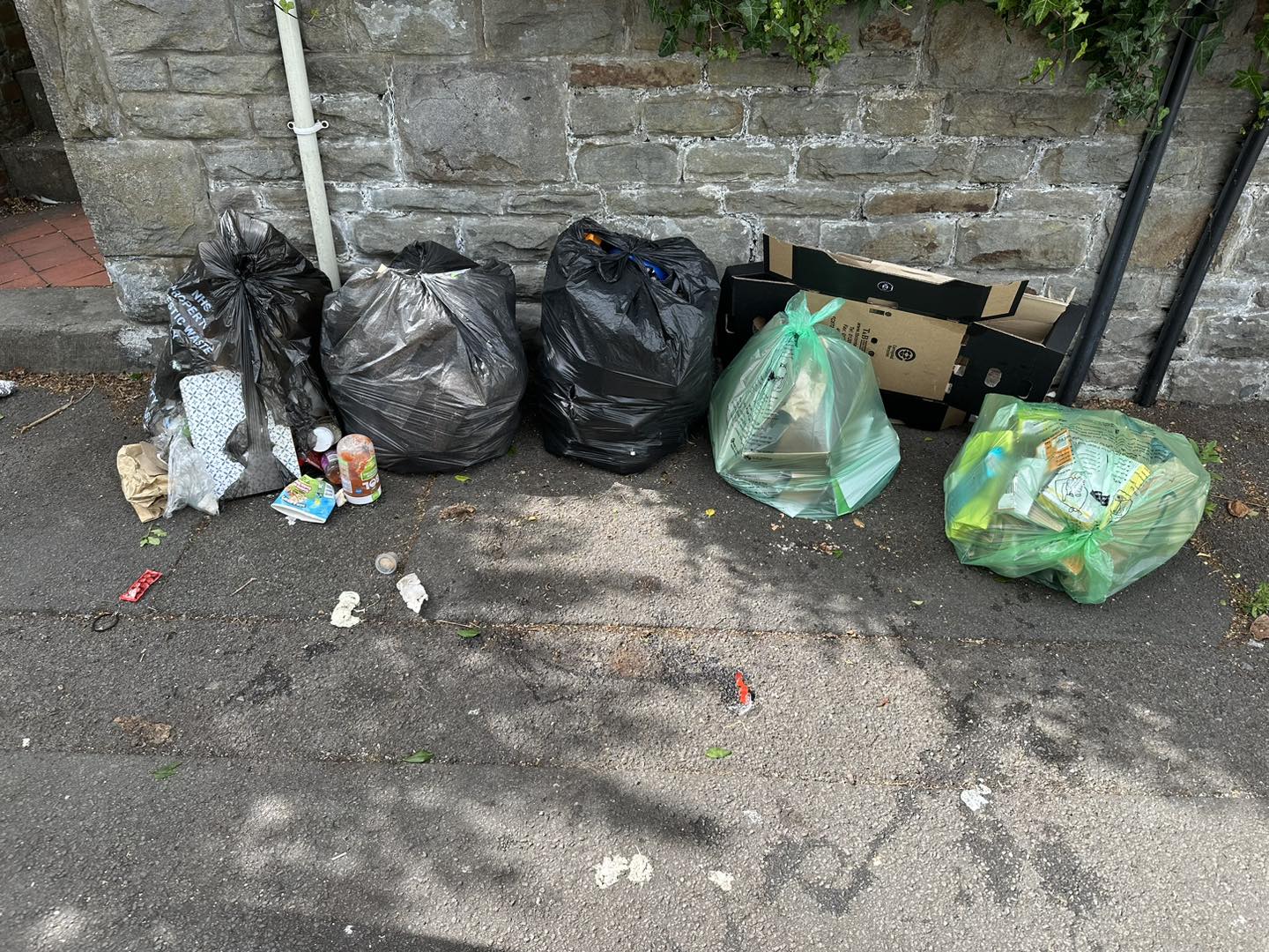 a photo of black bags and green bags in a yard in Neath, Port Talbot, And Swansea