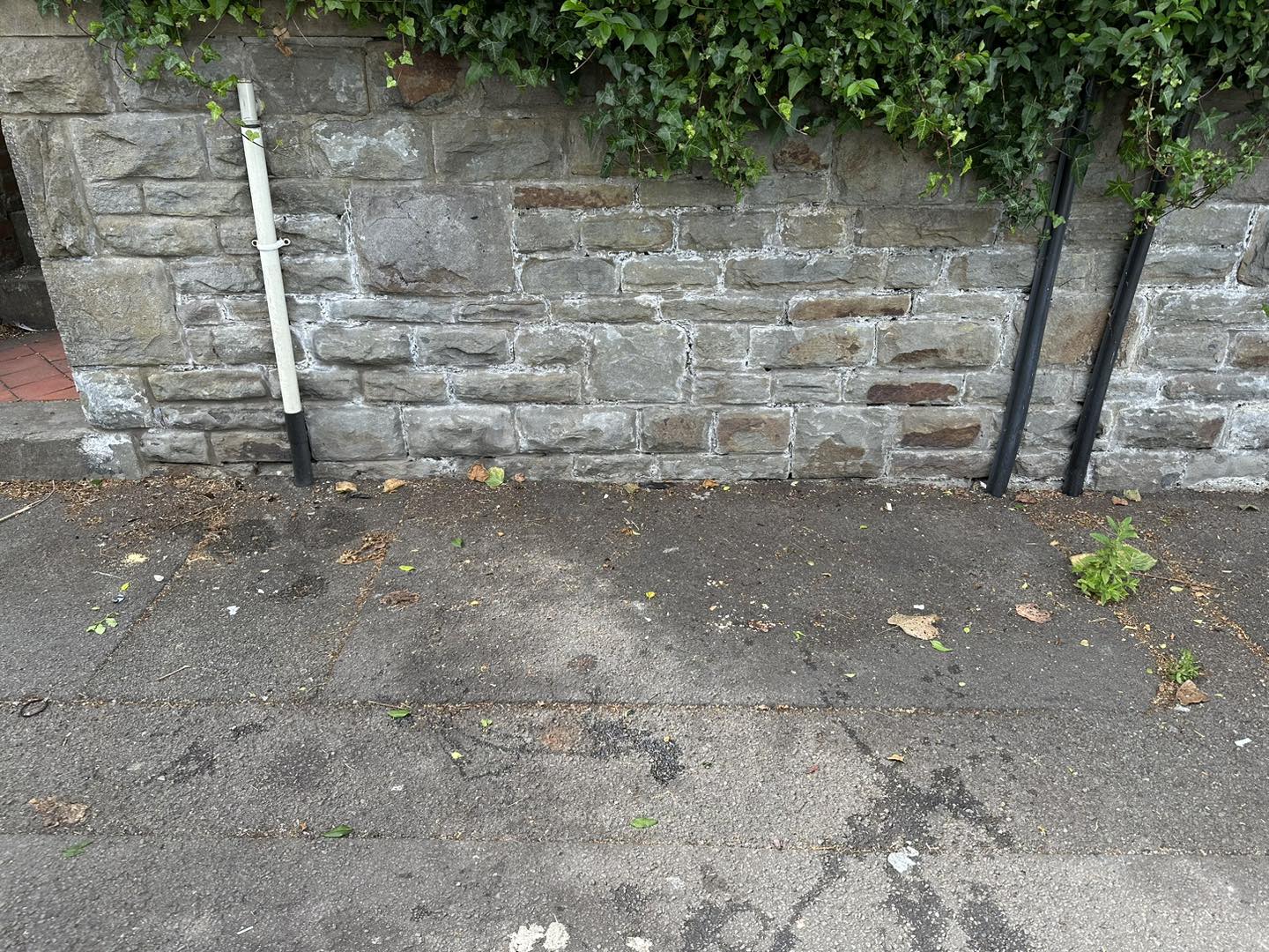 a photo of a stone wall in concrete yard in Neath, Port Talbot, And Swansea