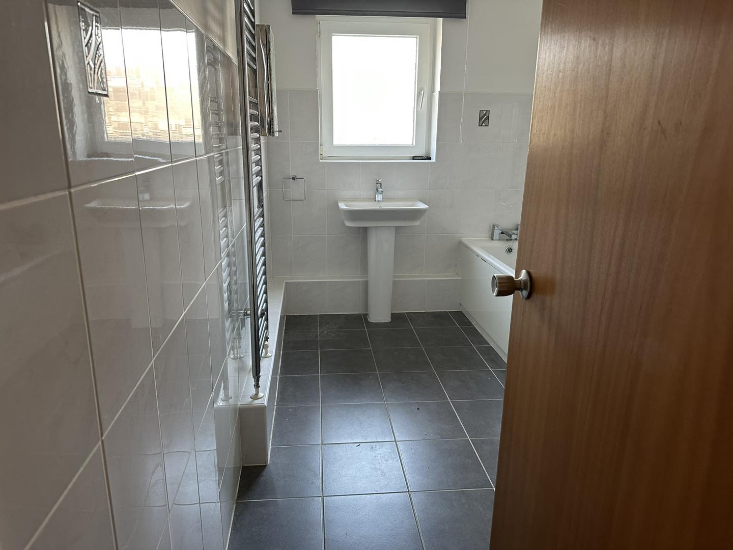 A photo of a clean bathroom in a house