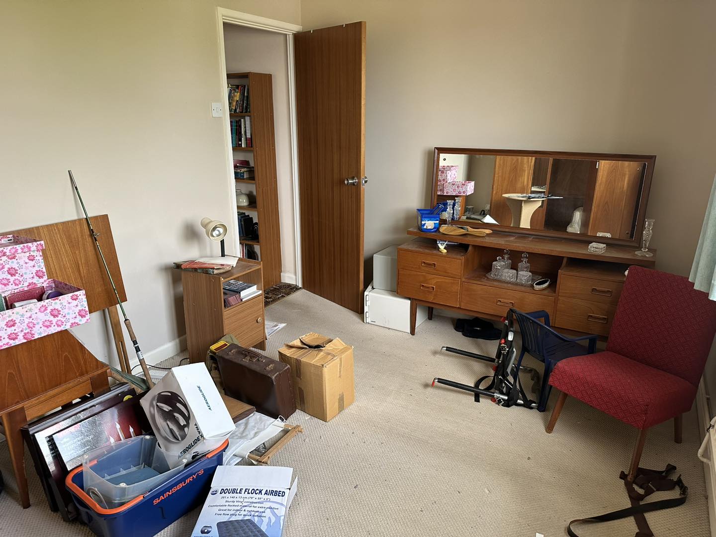 A photo of a bedroom in a house full of junk