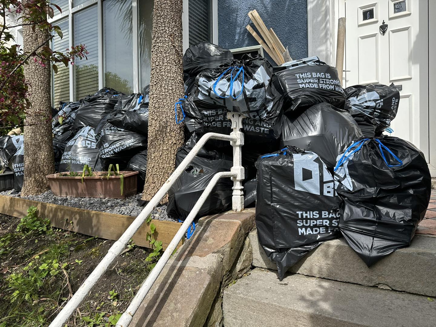 A photo of rubbish bags on garden floor