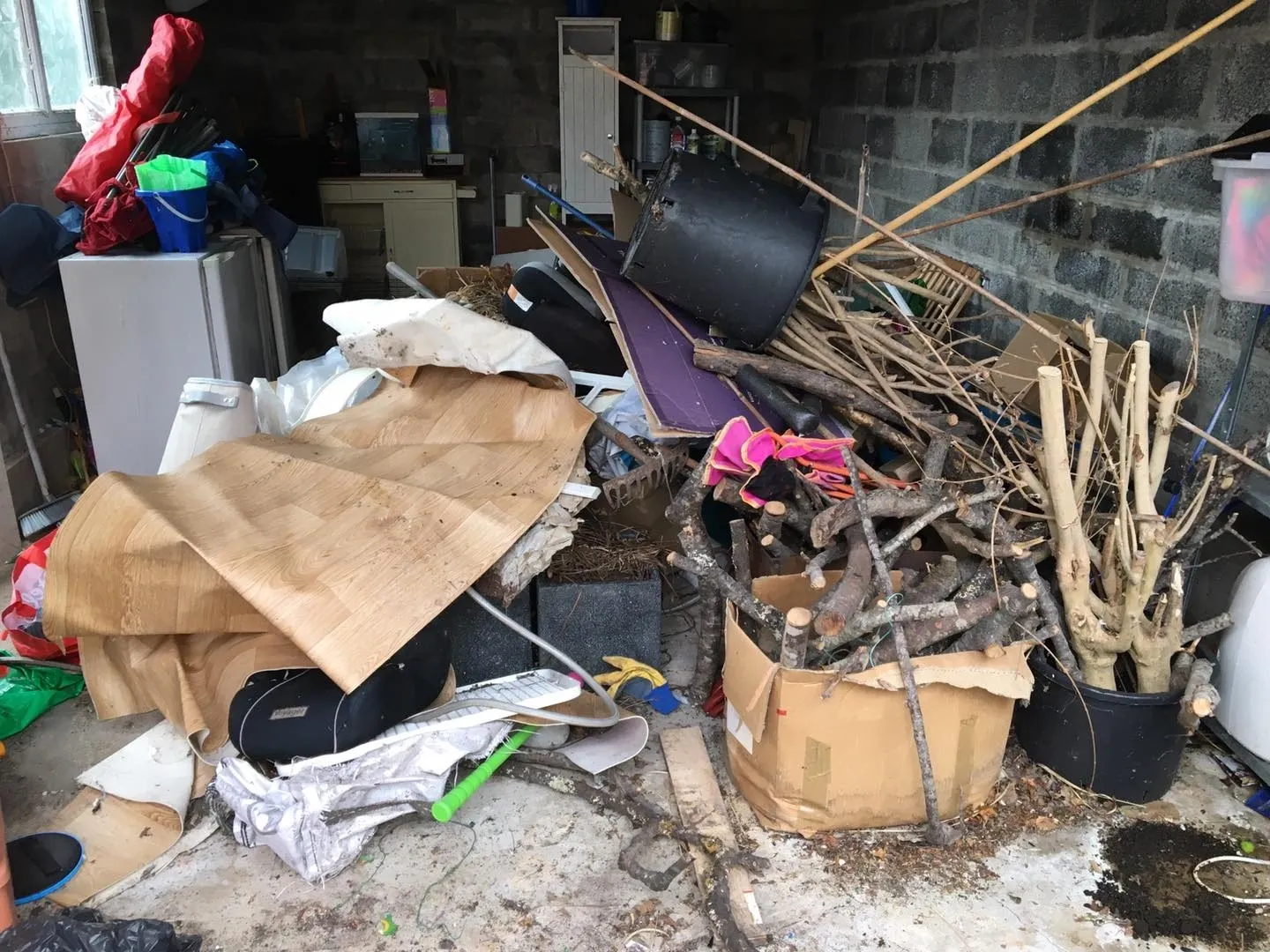 Photo of a small garage full of rubbish